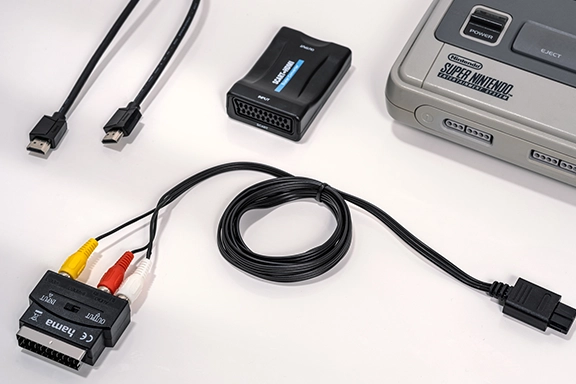 Multi-Out-AV-Kabel, Scart Adapter, Scart zu HDMI Konverter und HDMI Kabel liegen auf Tisch bereit.